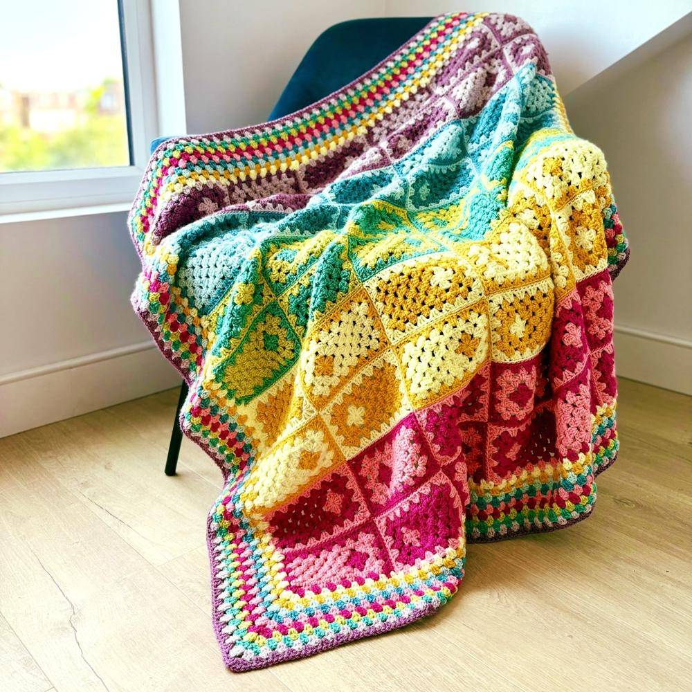Vibrant Rainbow Bordered Granny Square Crochet Blanket